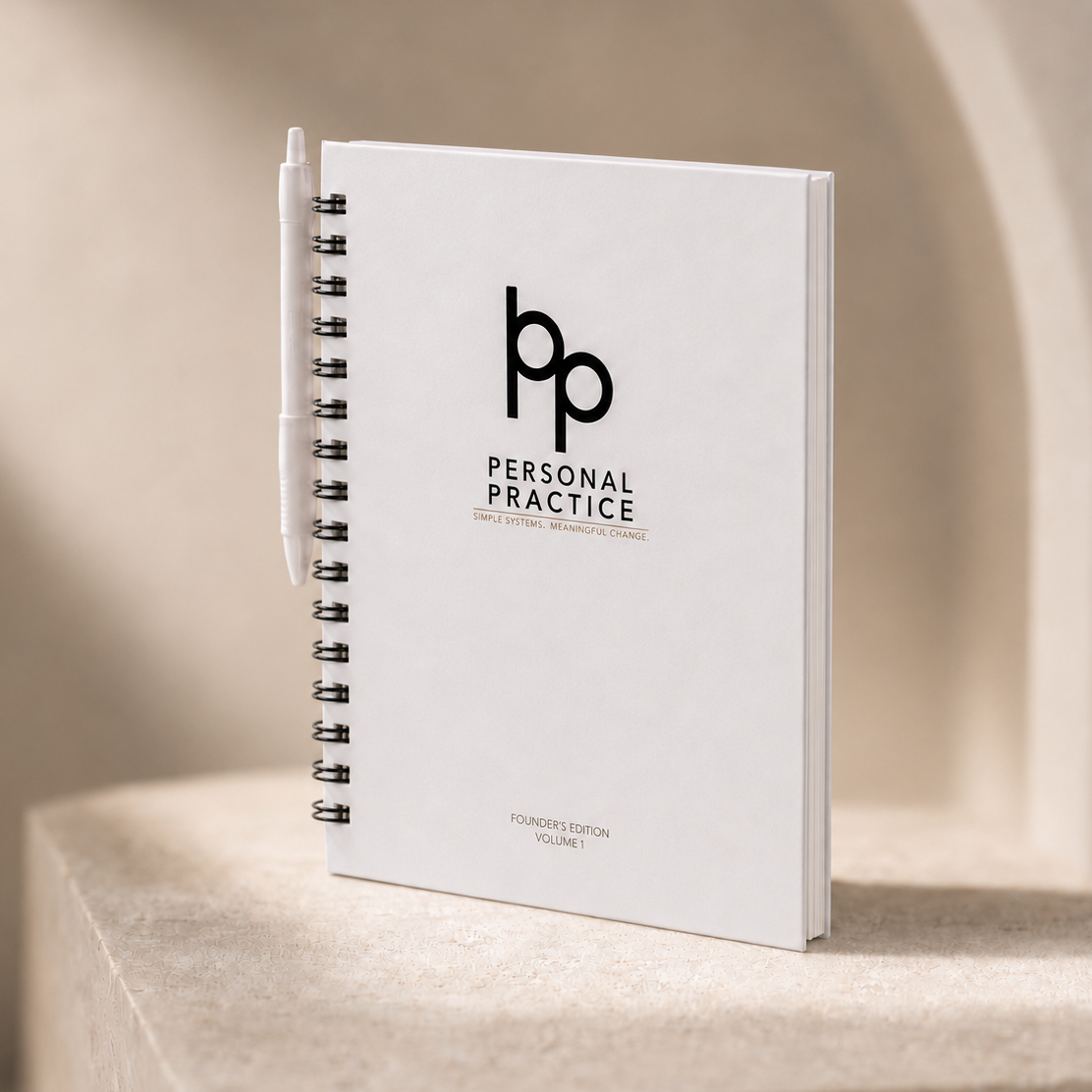 Practice One 12-week guided strength journal displayed on a wooden shelf.